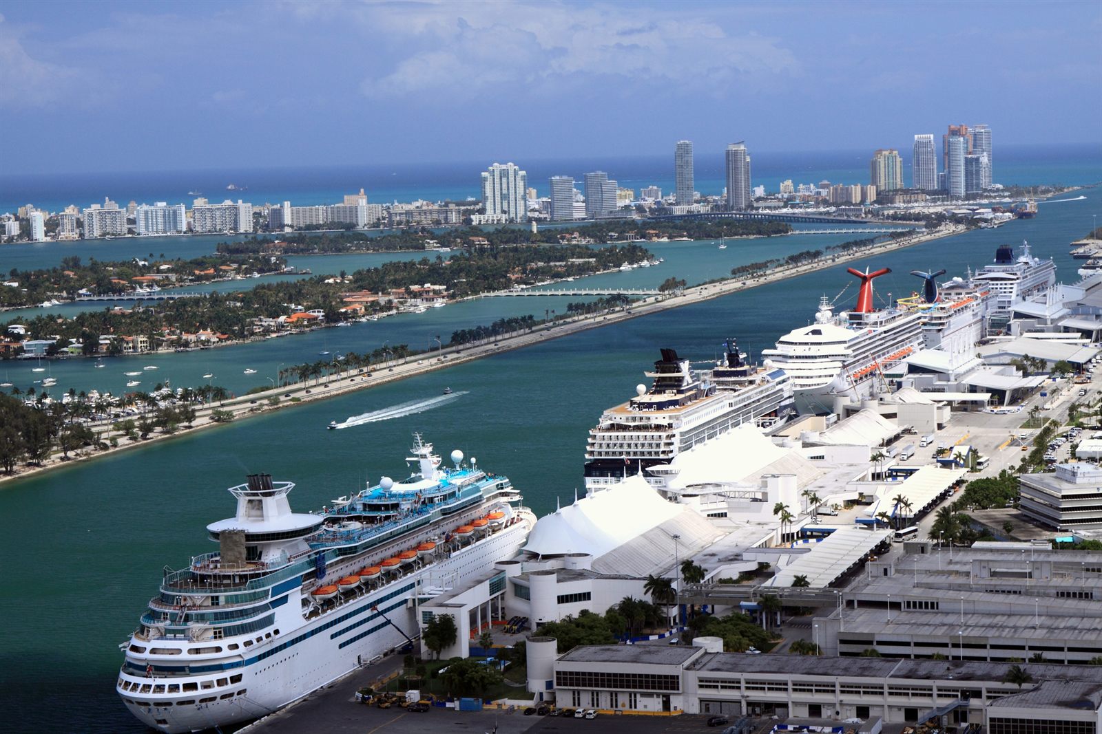 Aerial view of cruise ships docked at PortMiami with Miami Beach behind